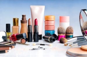 A variety of cosmetics and makeup products on a table.