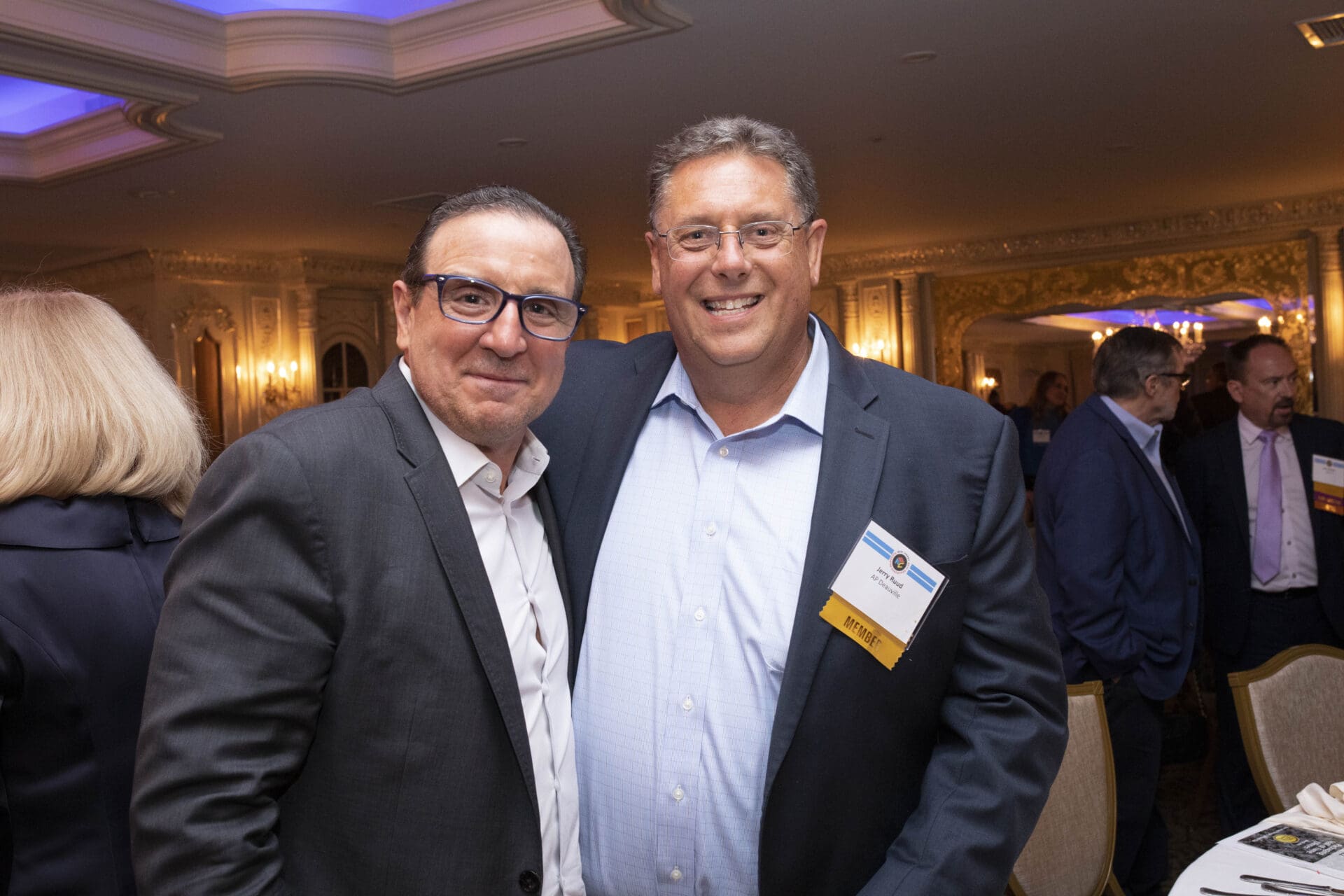 Two men posing for a photo at a business event.