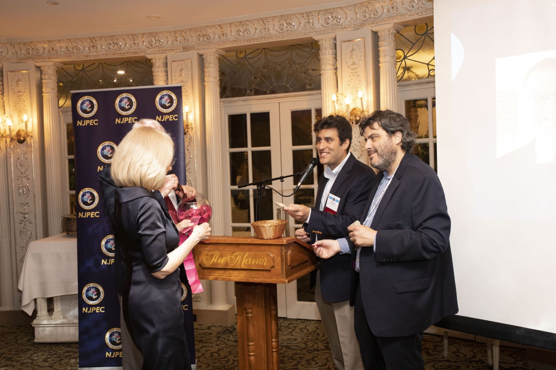 Three people standing at a podium.