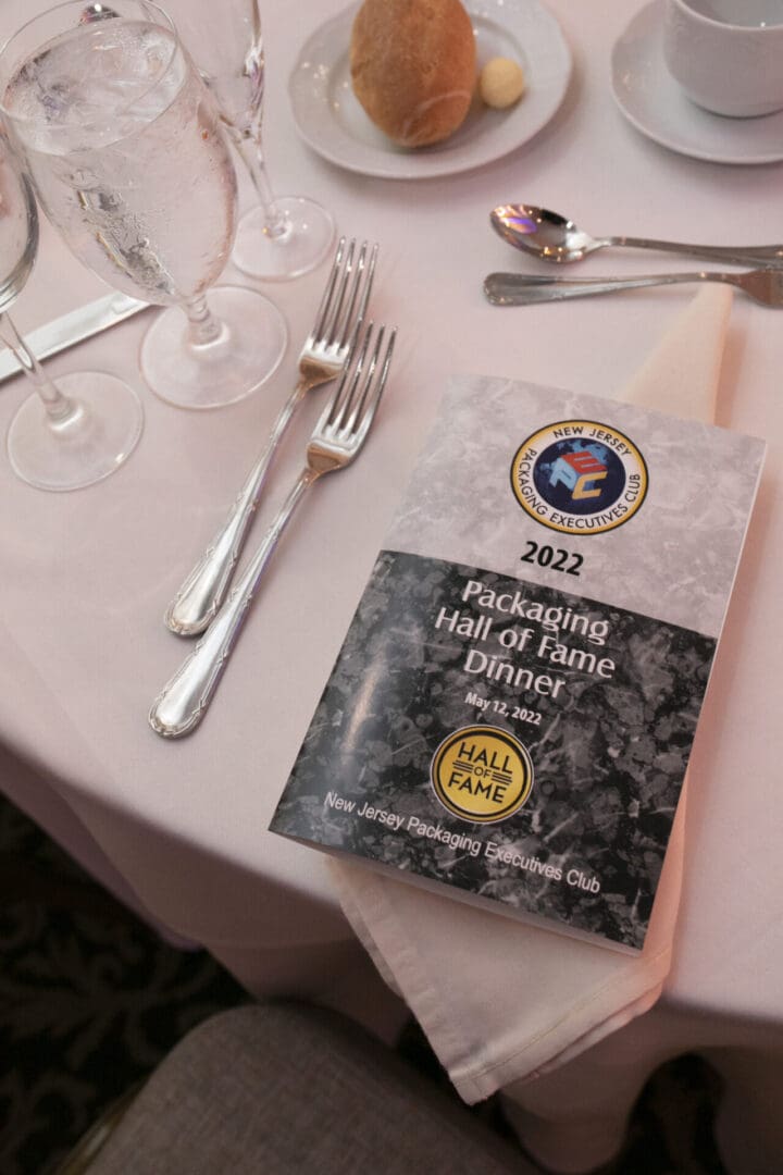 A book on the table that says Packaging hall of fame dinner