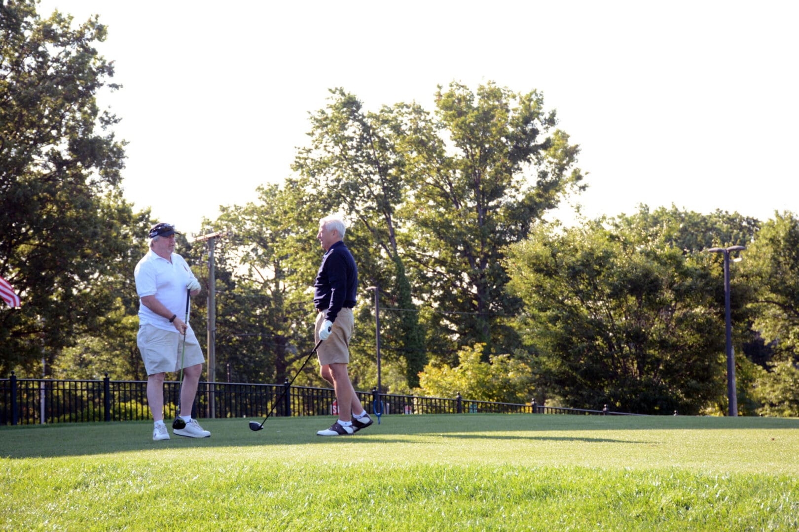 two men with white hair playing golf