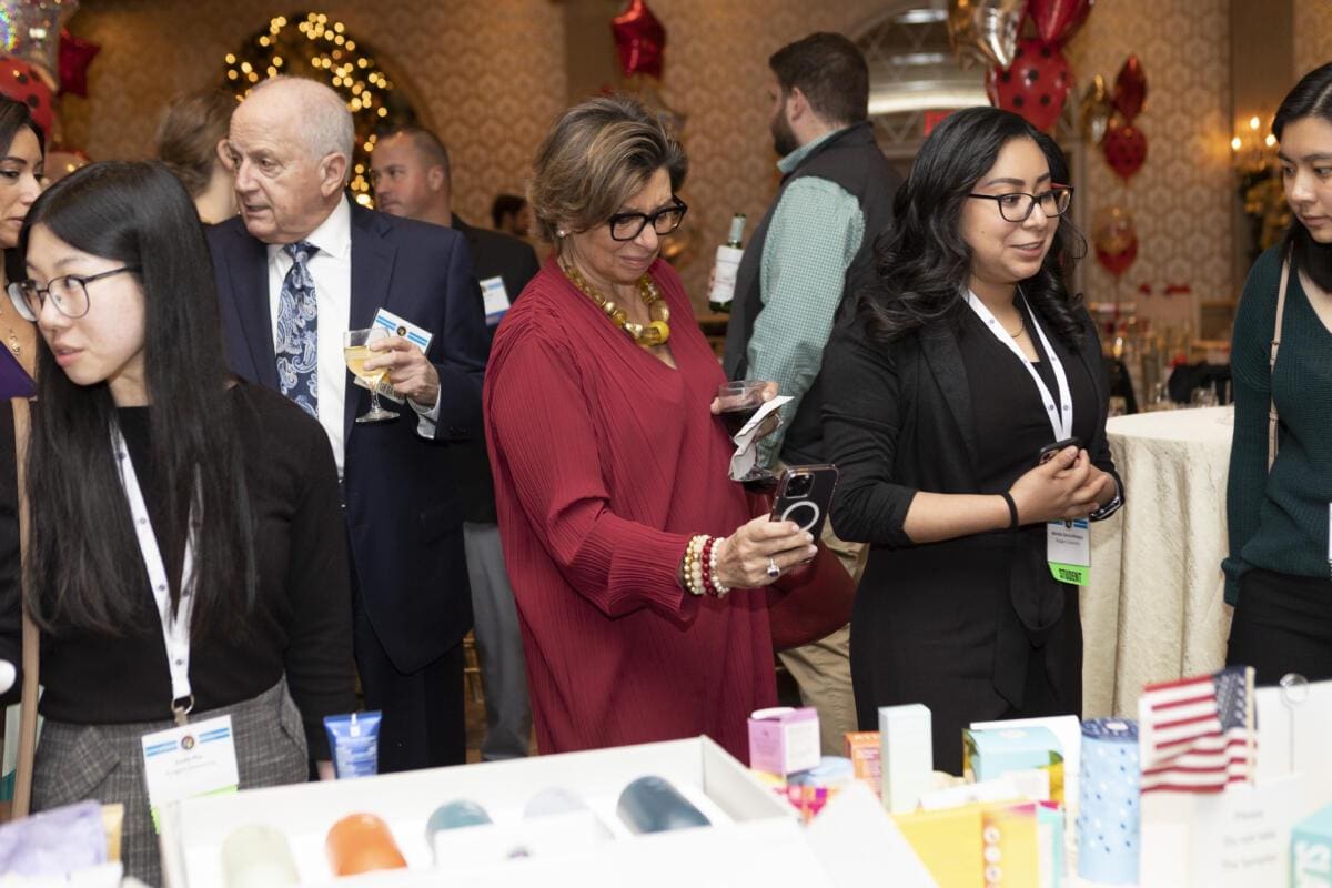 A group of people looking at products at an event.