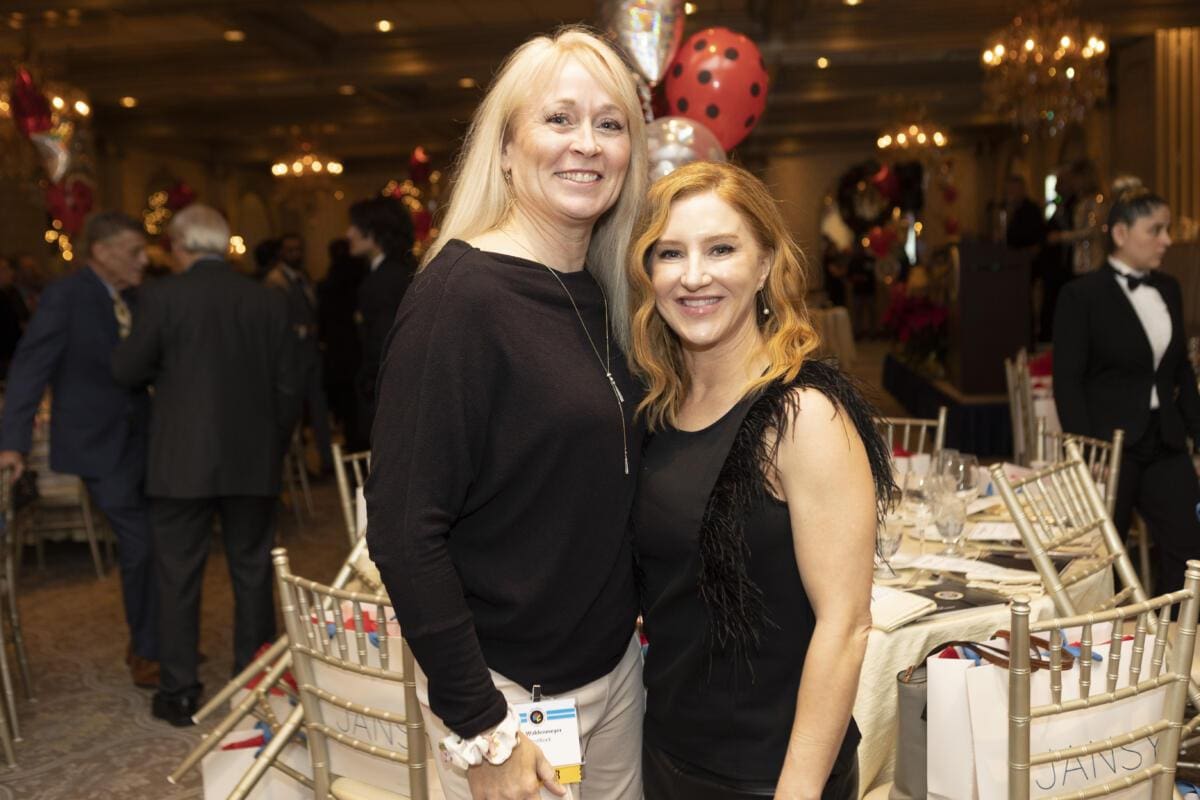 Two women standing next to each other at an event.