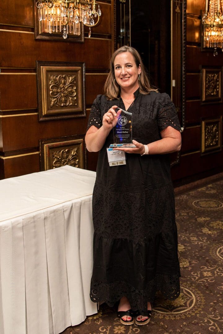 woman with a glass award trophy
