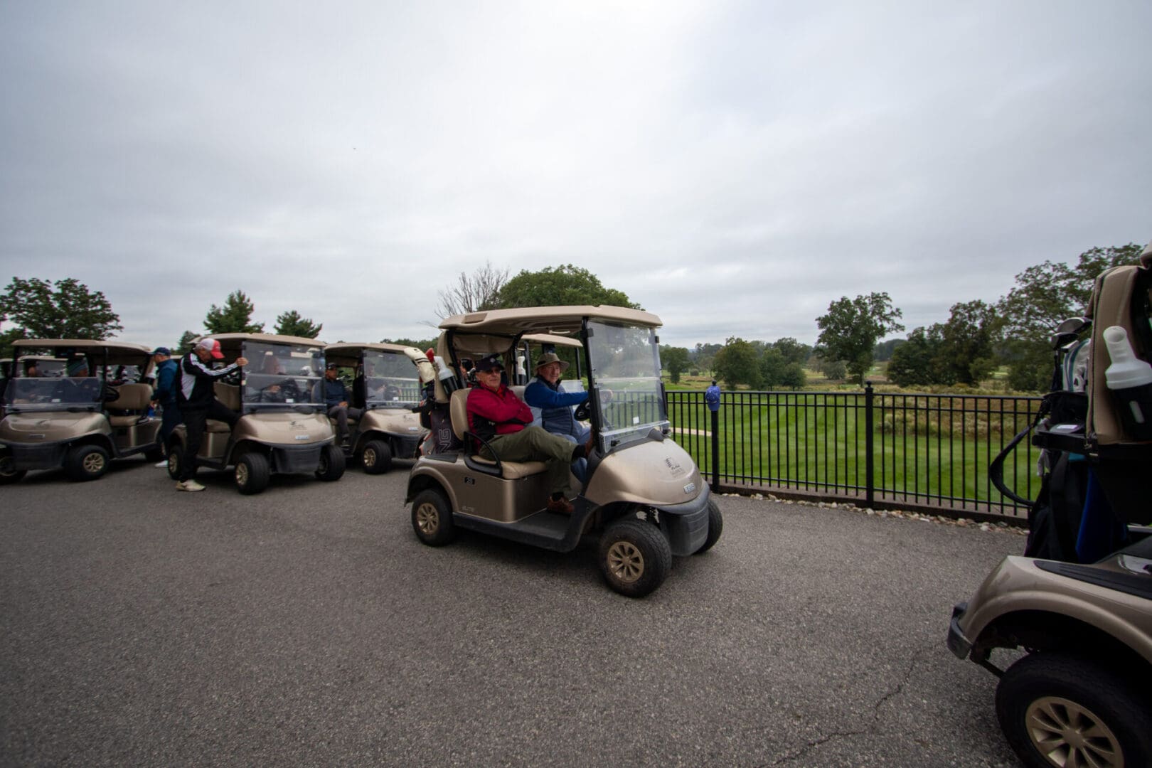 two men travelling on a golf cart