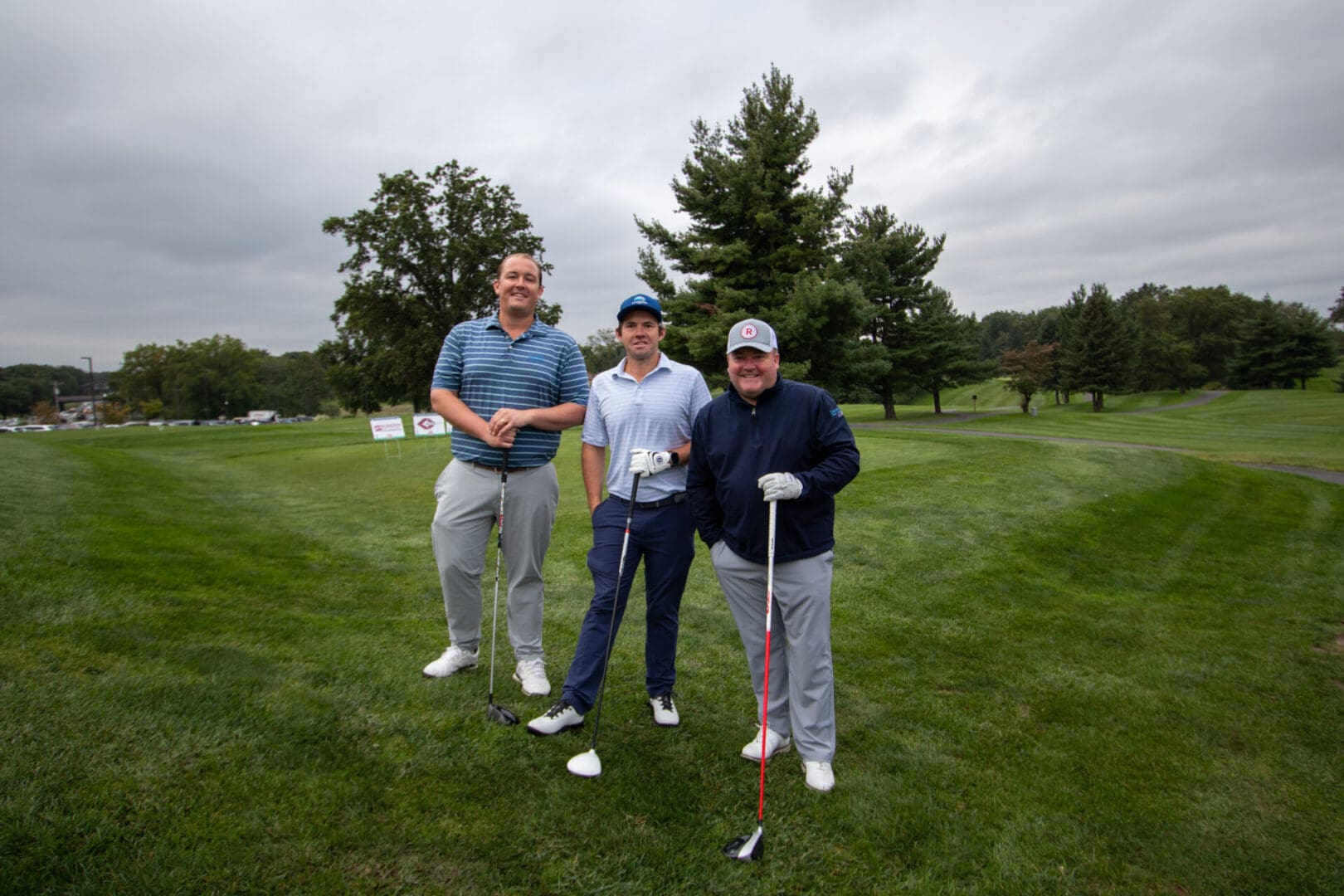 3 men on an elevated golf course