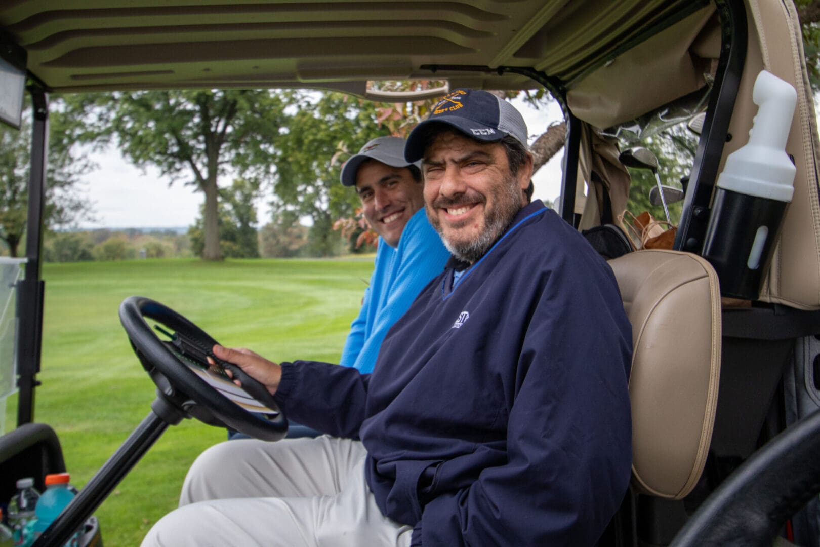 2 men on a golf cart
