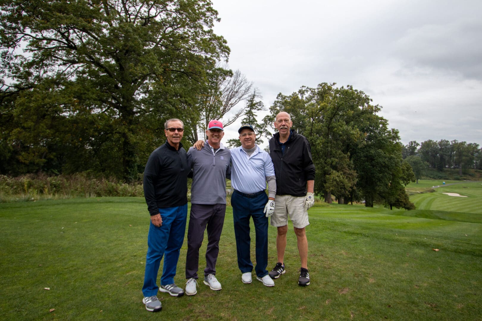 4 golfers posing