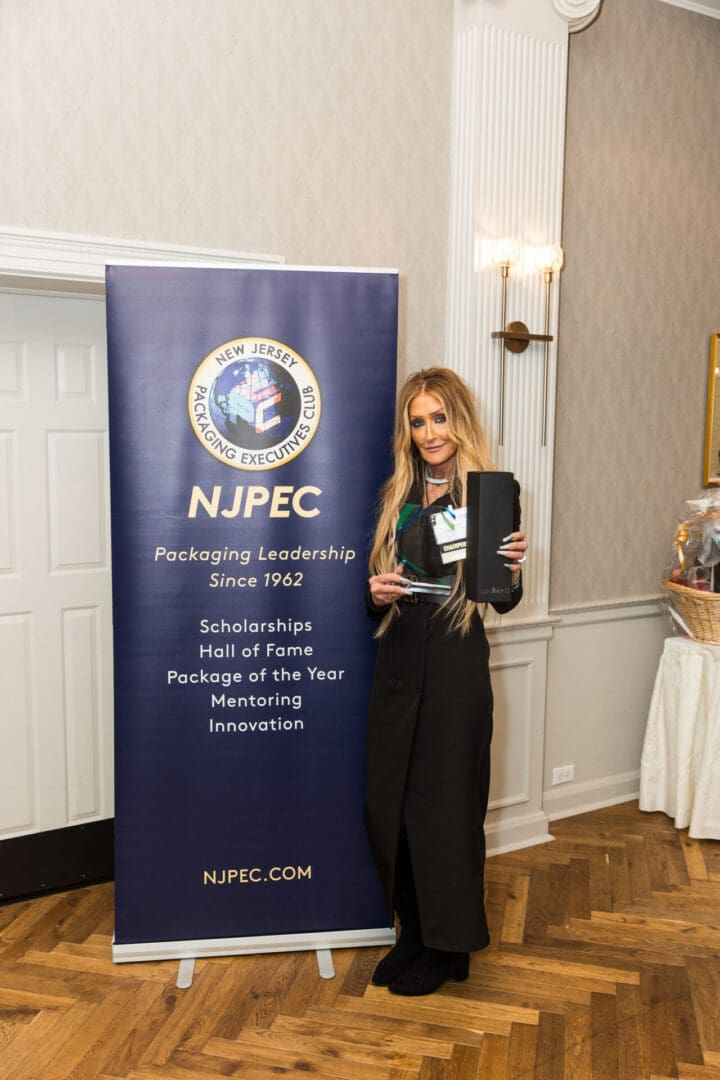 A woman standing in front of a banner that says nupec.