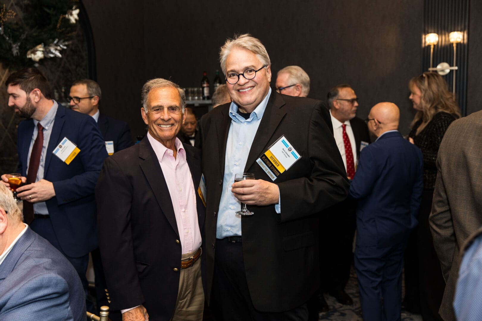 Two men standing next to each other at a business event.