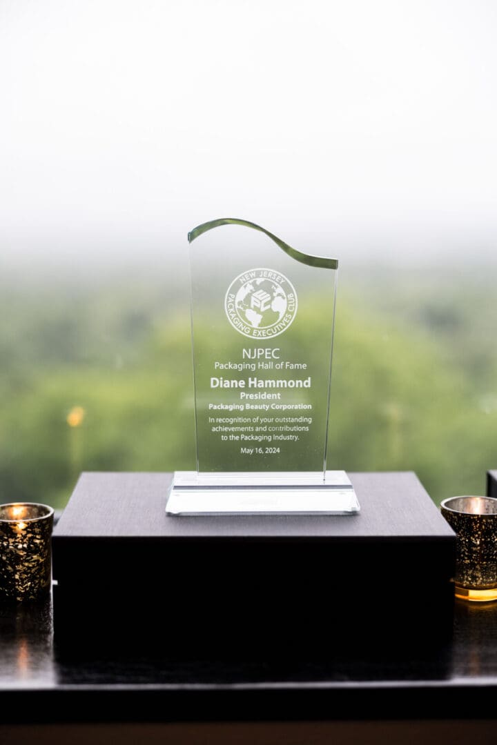 An award on a table with two candles.