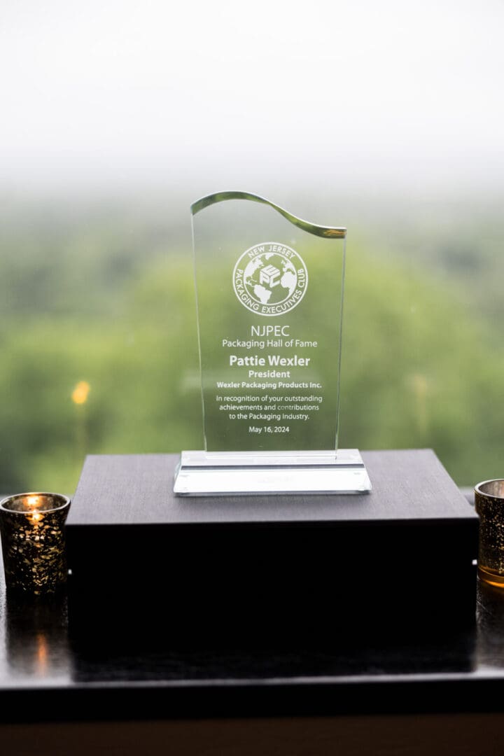 An award on a table with a green background.